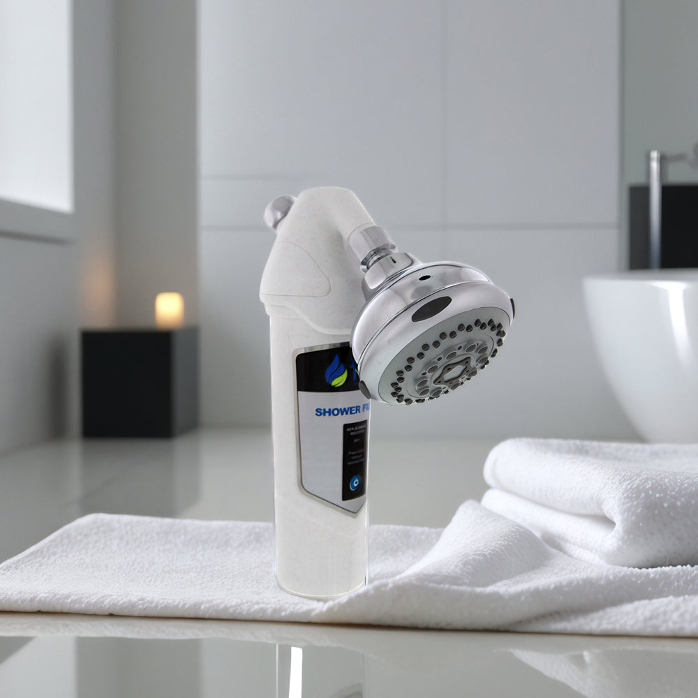 A white shower head with a neatly placed towel resting on top, showcasing a clean and organized bathroom setting.