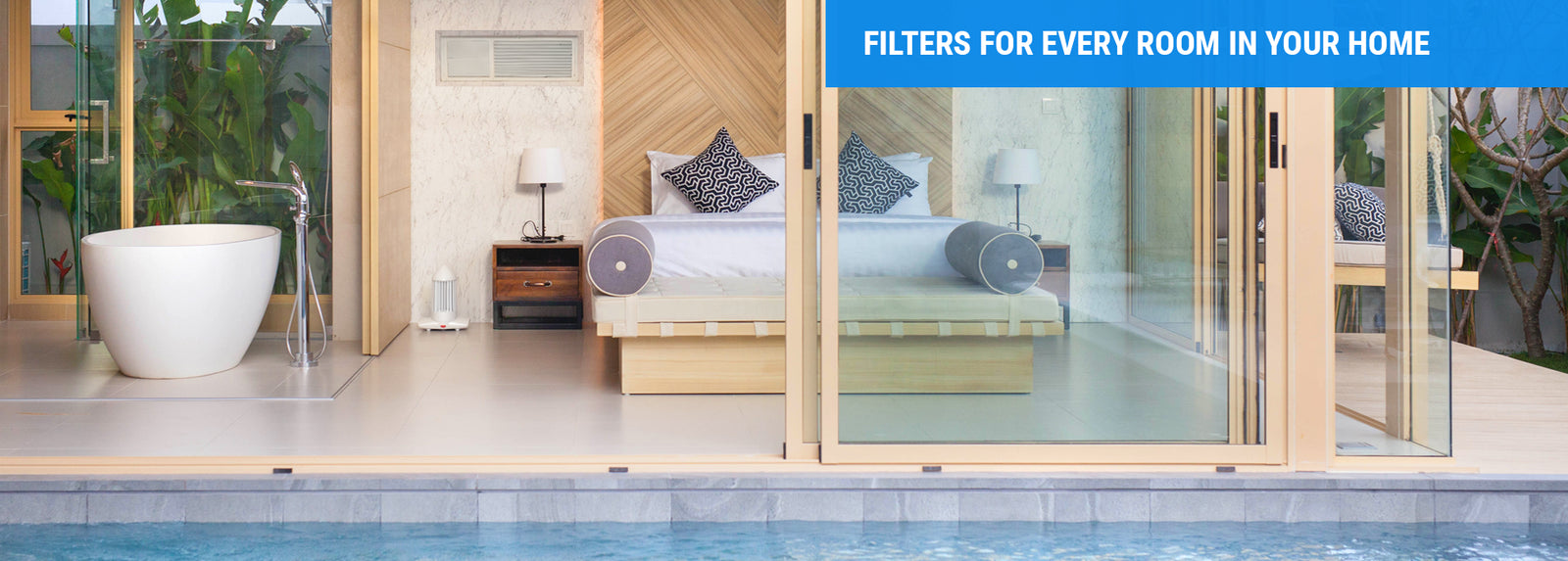A serene bedroom with a bed positioned near a glass door, inviting light and views from outside.